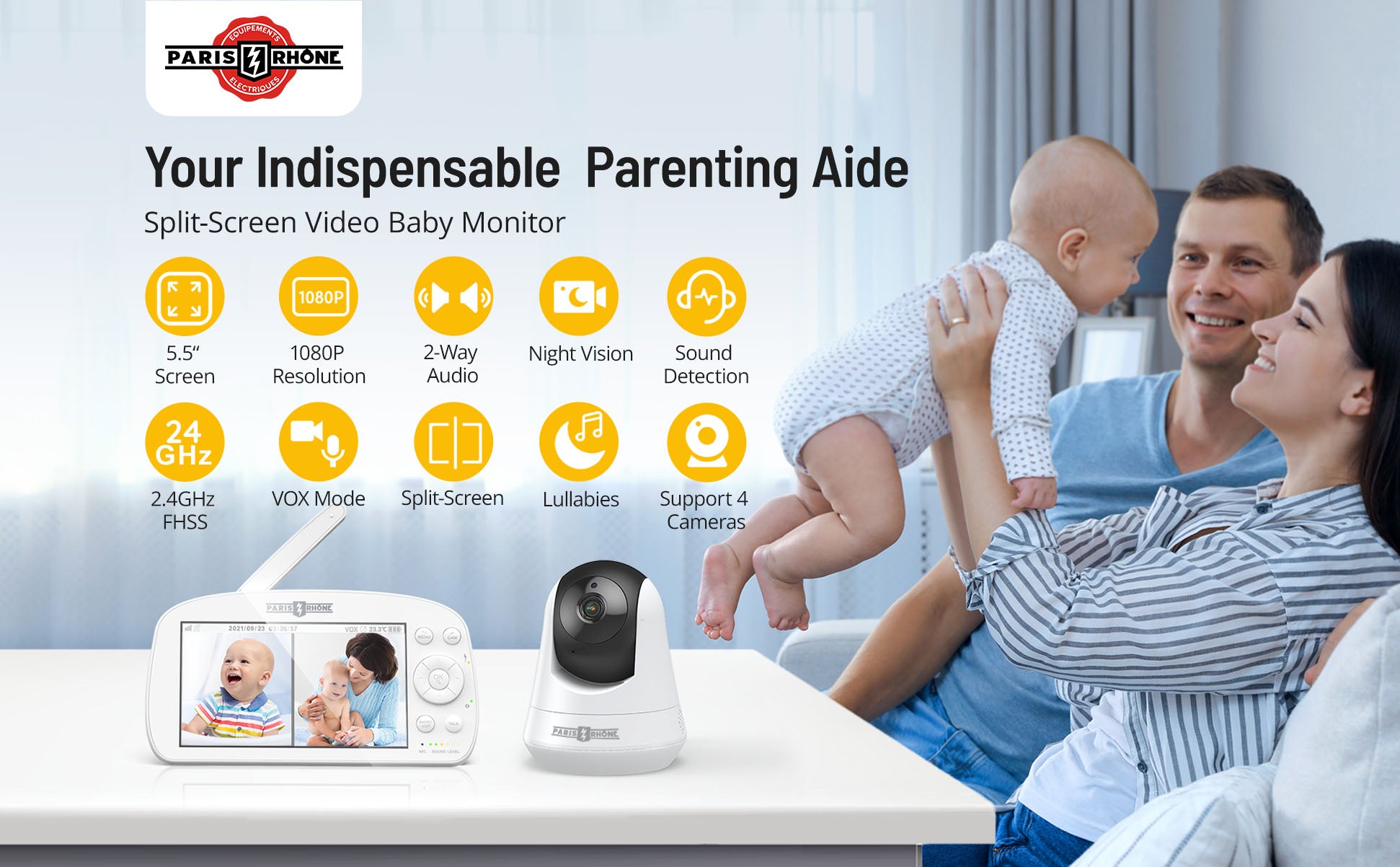 A baby monitor and camera is displayed on a table with a mother holding her baby on a coach next to her smiling husband. 